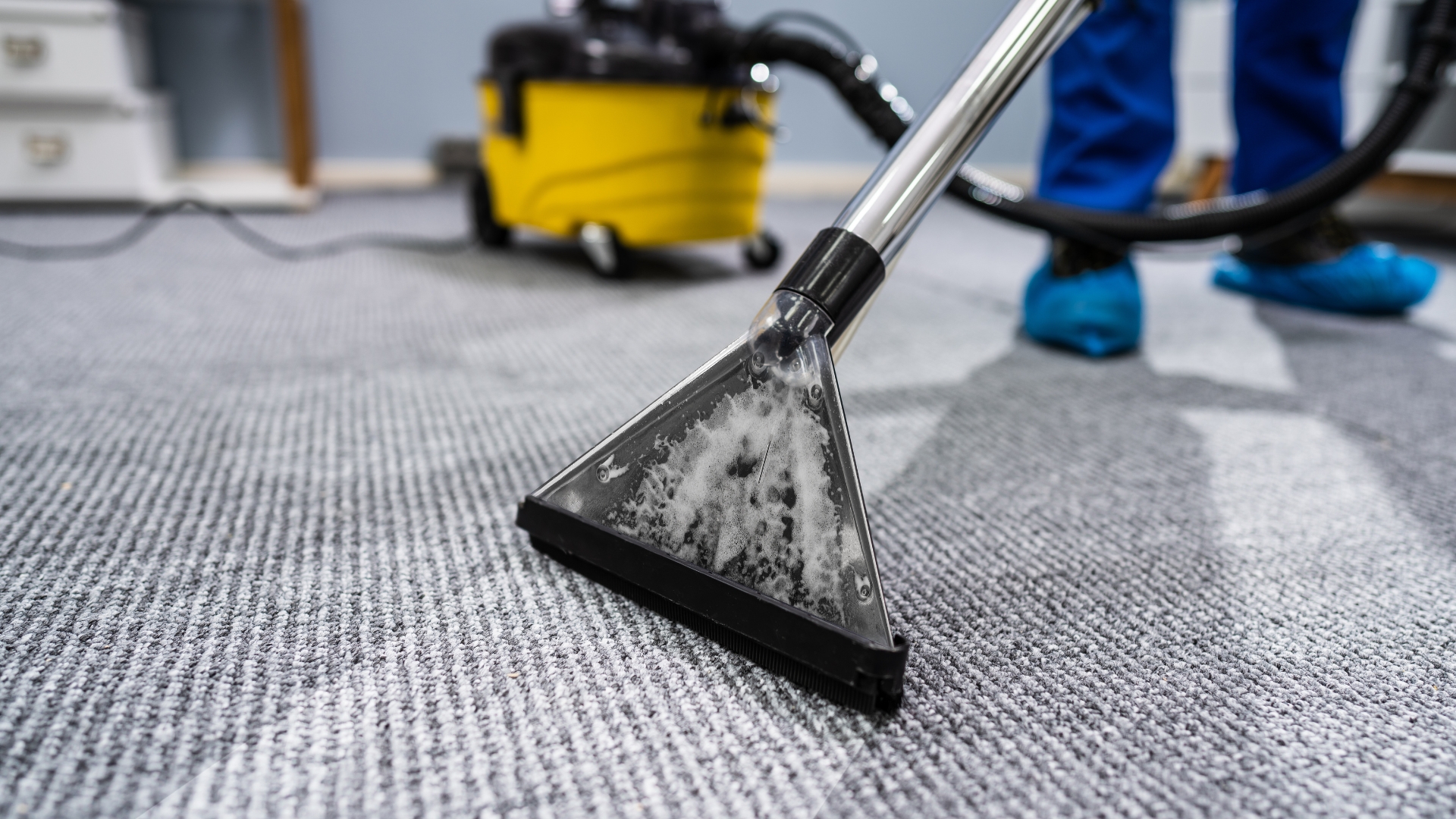 A powerful carpet cleaning tool lifting dirt from an office carpet.